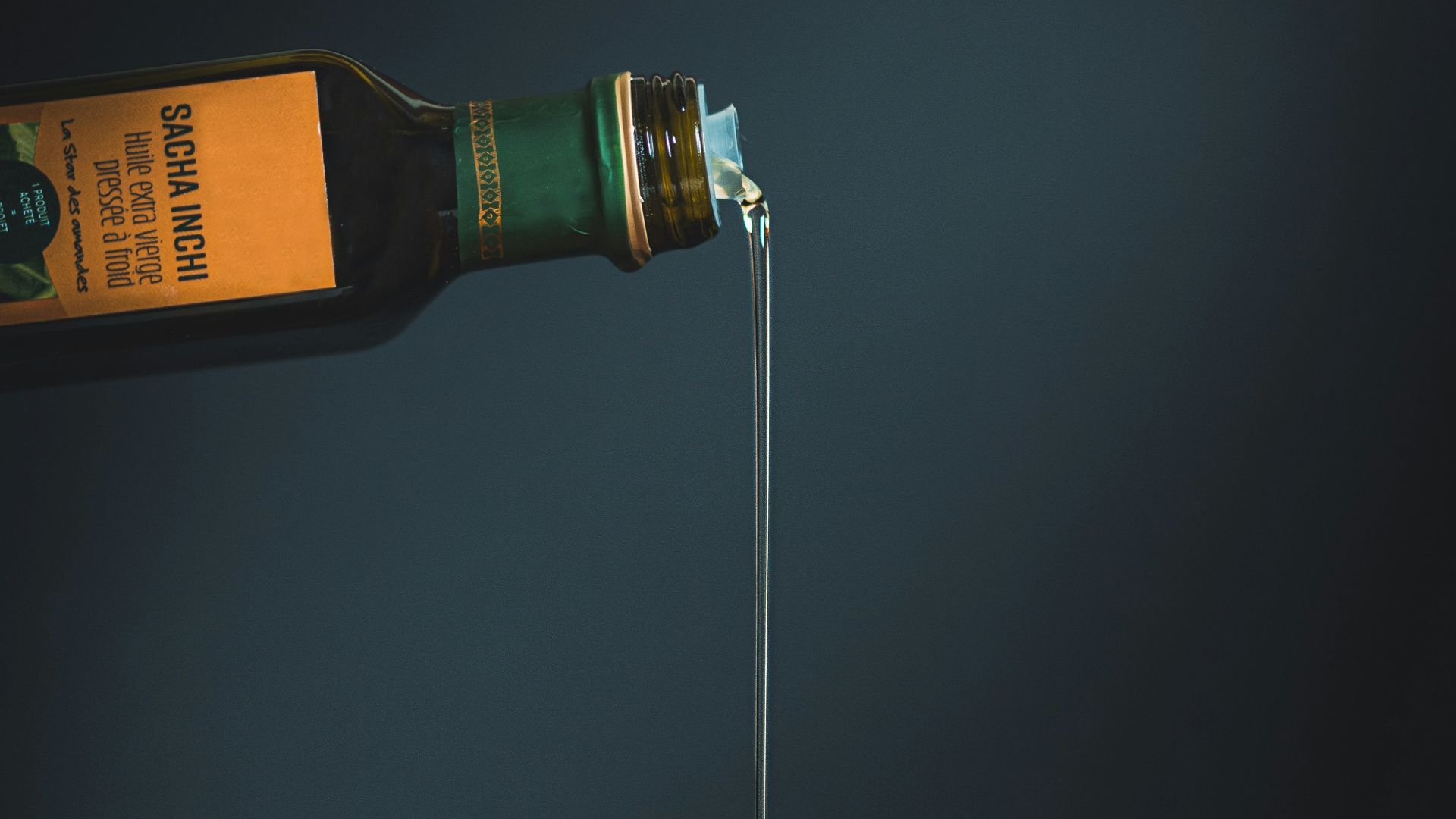 bottle with white liquid pouring through the brown slab