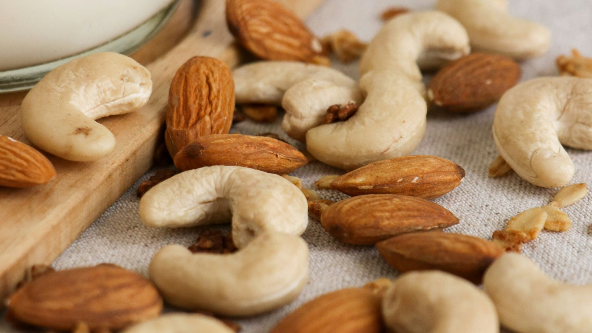 brown almond nuts on white textile