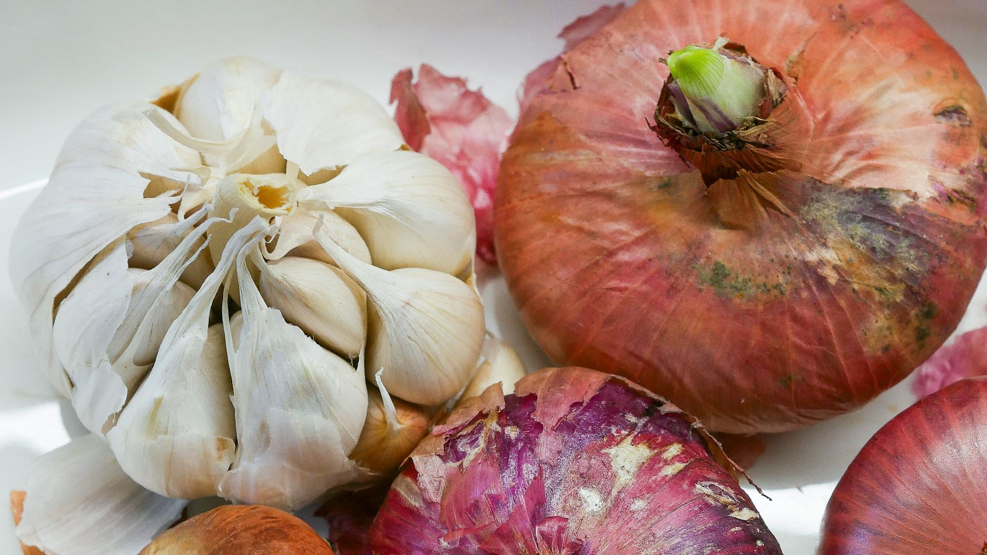 a white plate topped with onions and garlic
