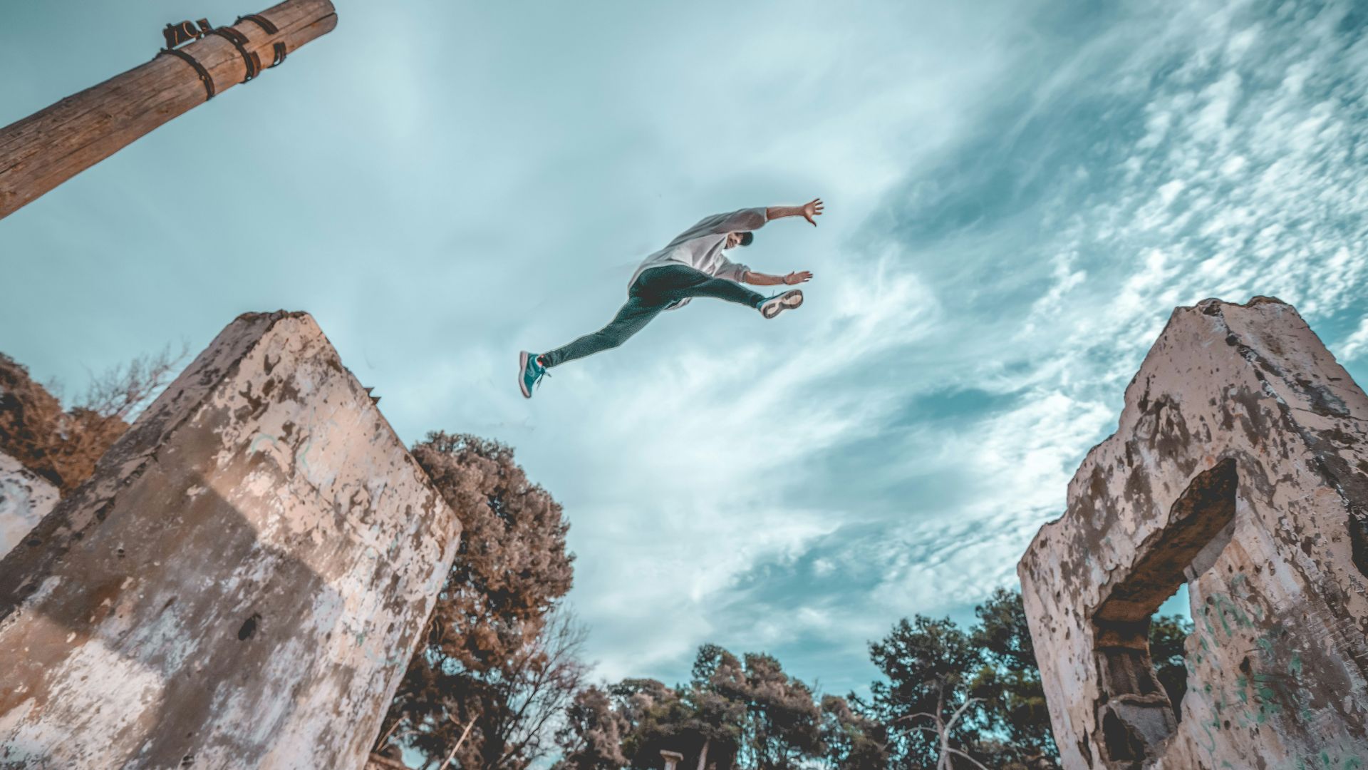 man jumping off next concrete wall