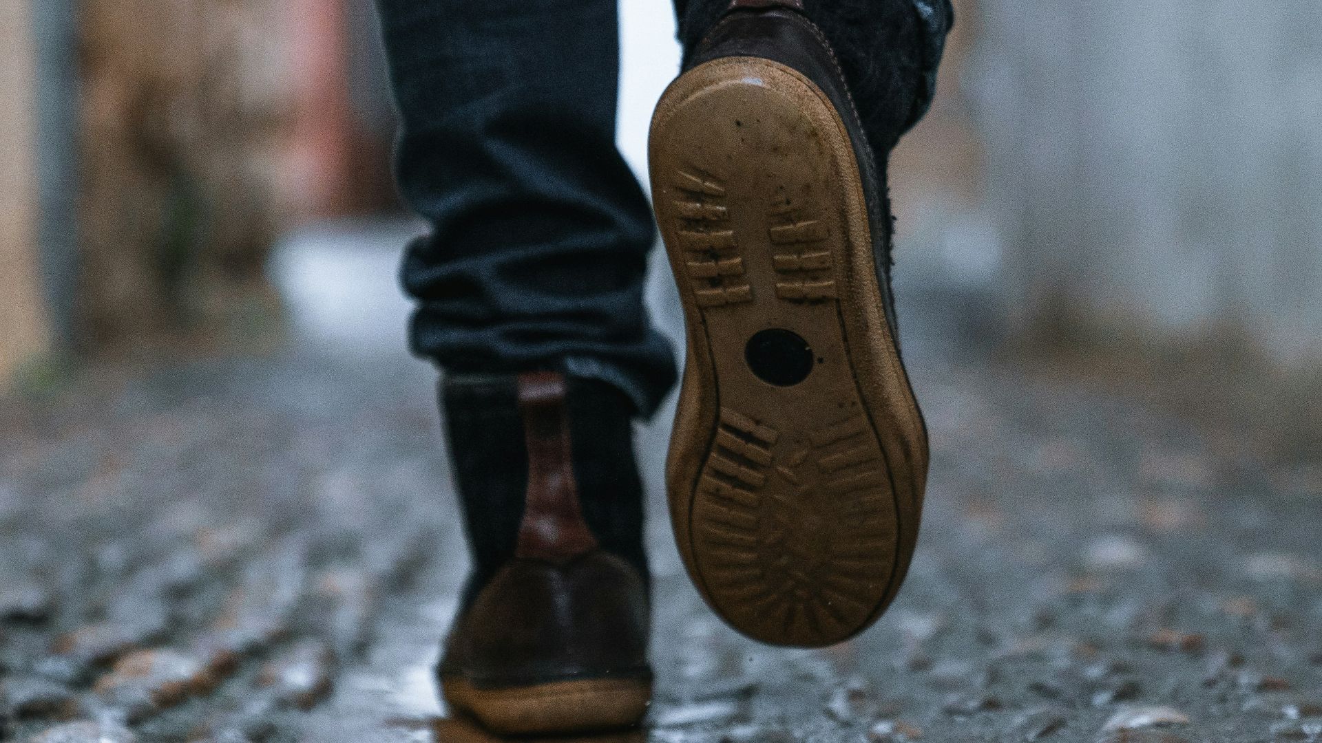 close-up photography of person walking on pavement