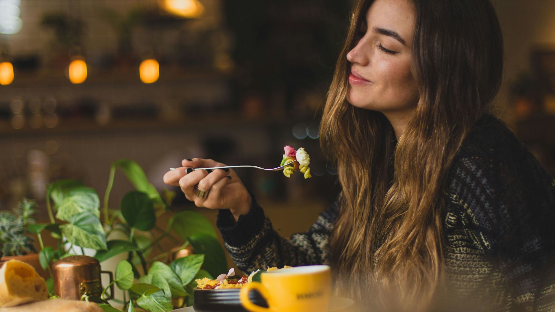 woman holding fork in front table