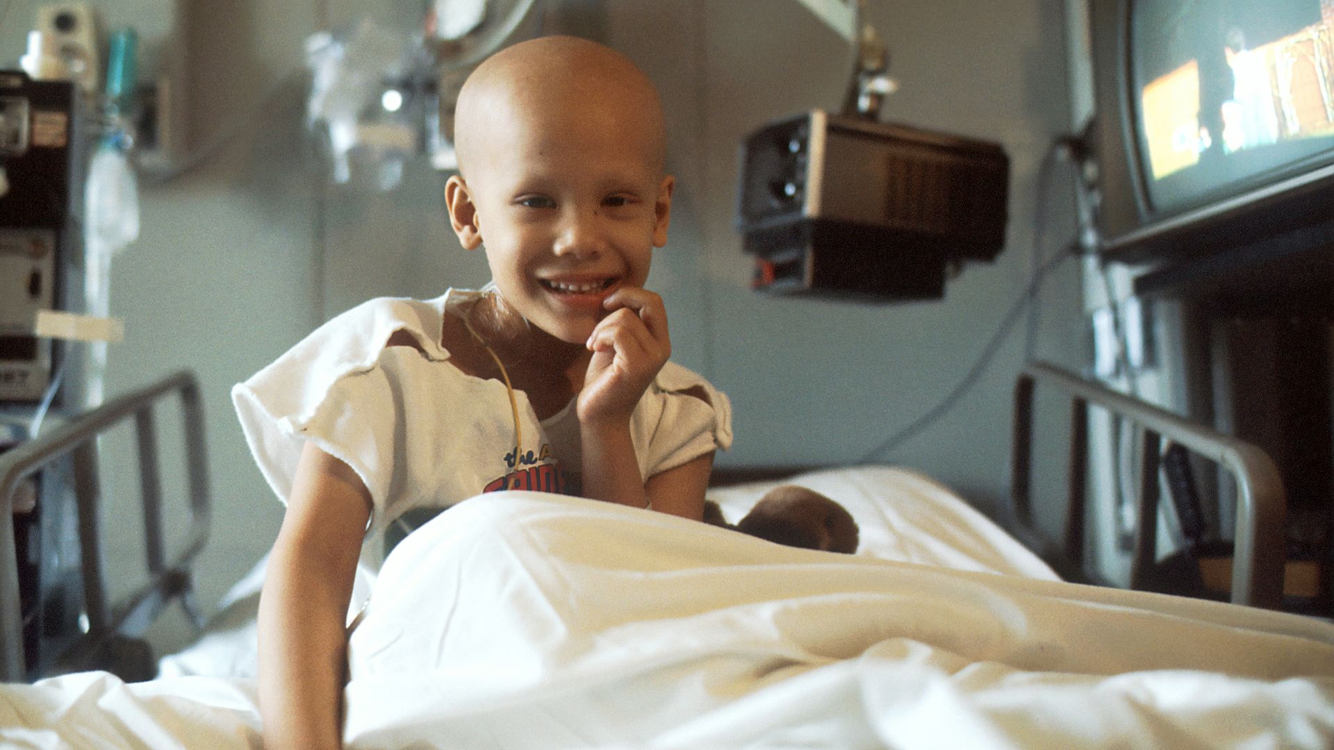 child sitting on bed