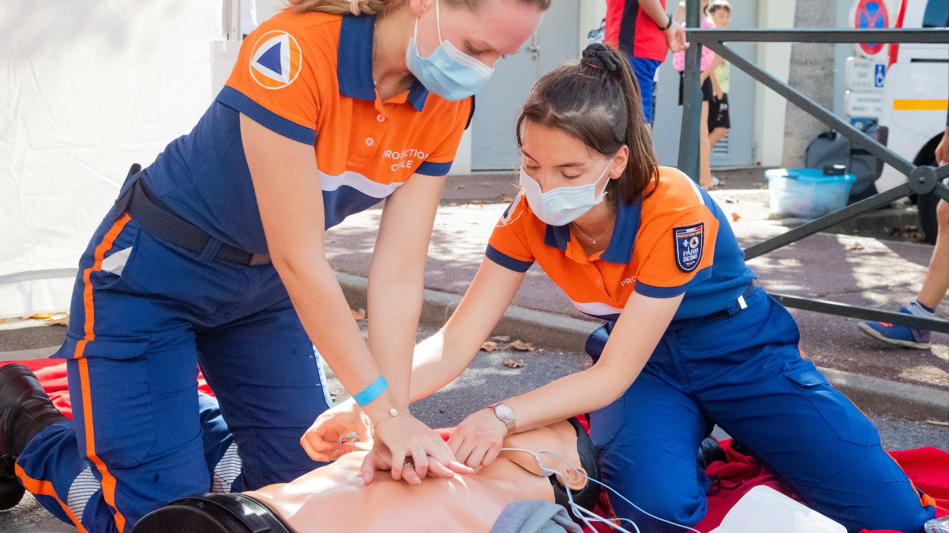 woman in blue t-shirt and blue pants holding baby