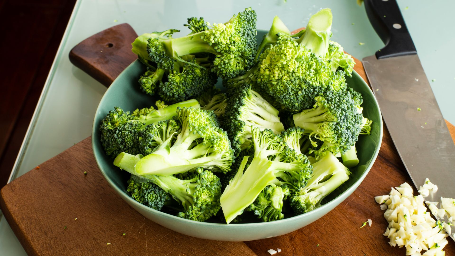 green broccoli on brown wooden chopping board