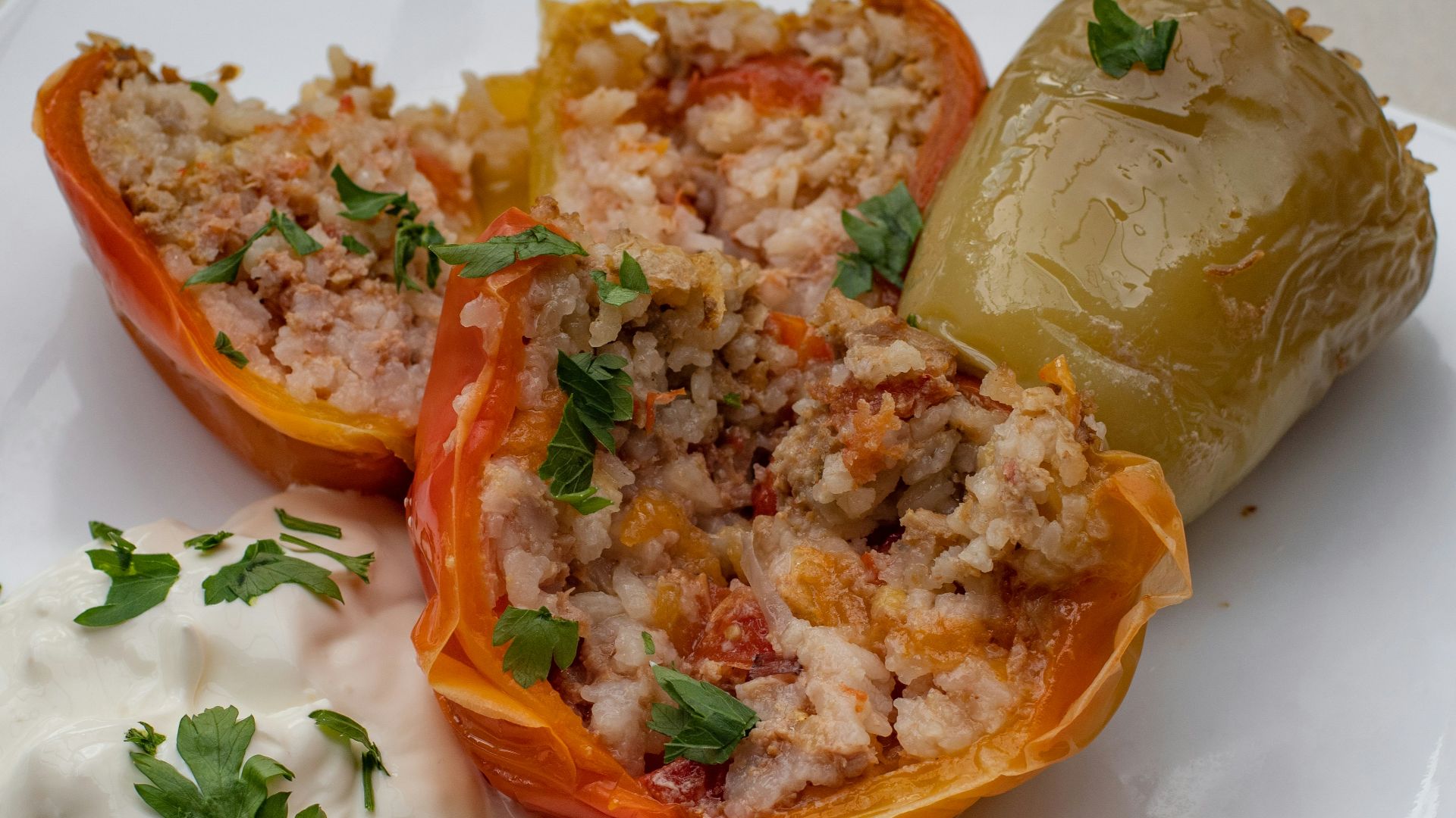 a white plate topped with stuffed bell peppers