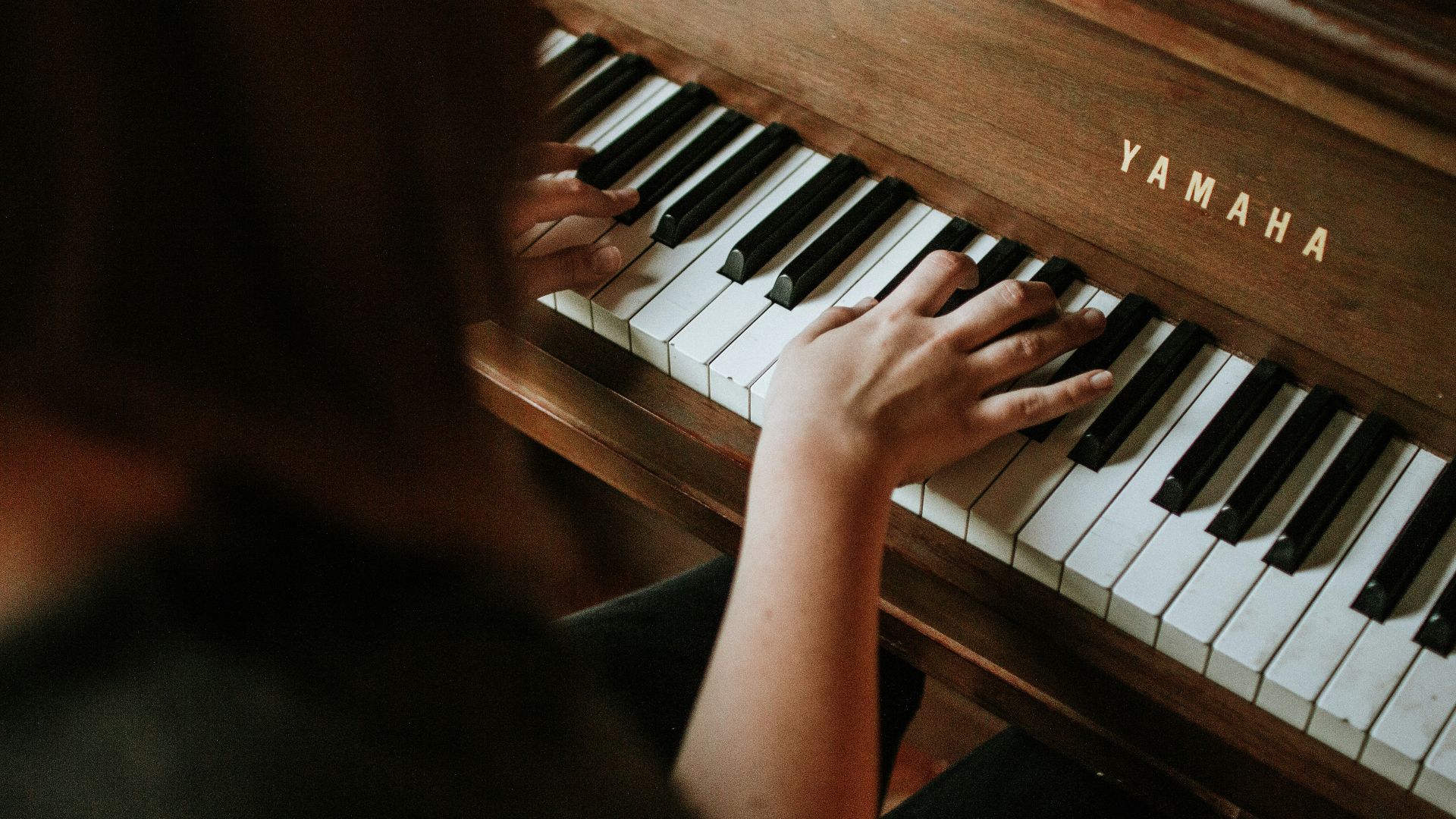 woman playing Yamaha piano