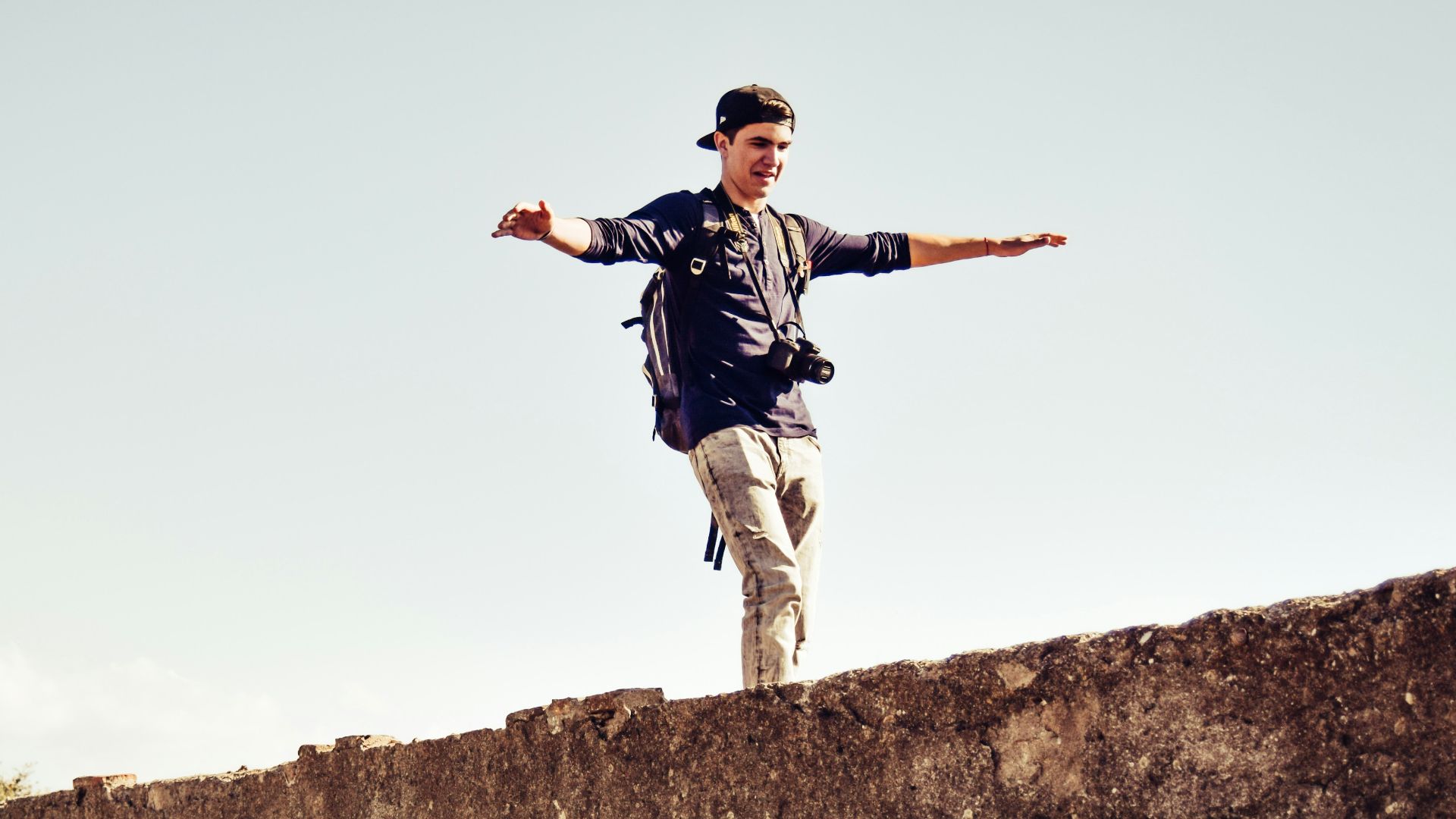man standing on gray concrete stone during daytime