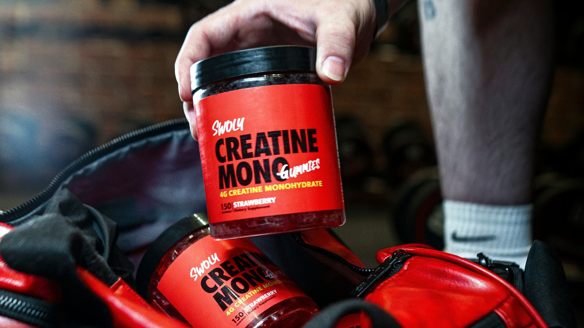 a man is holding a cup of coffee in a duffel bag