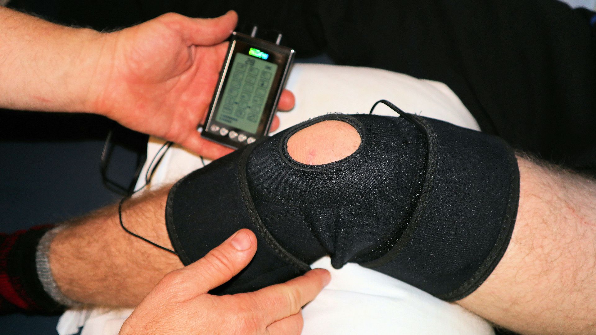 person holding black knit cap