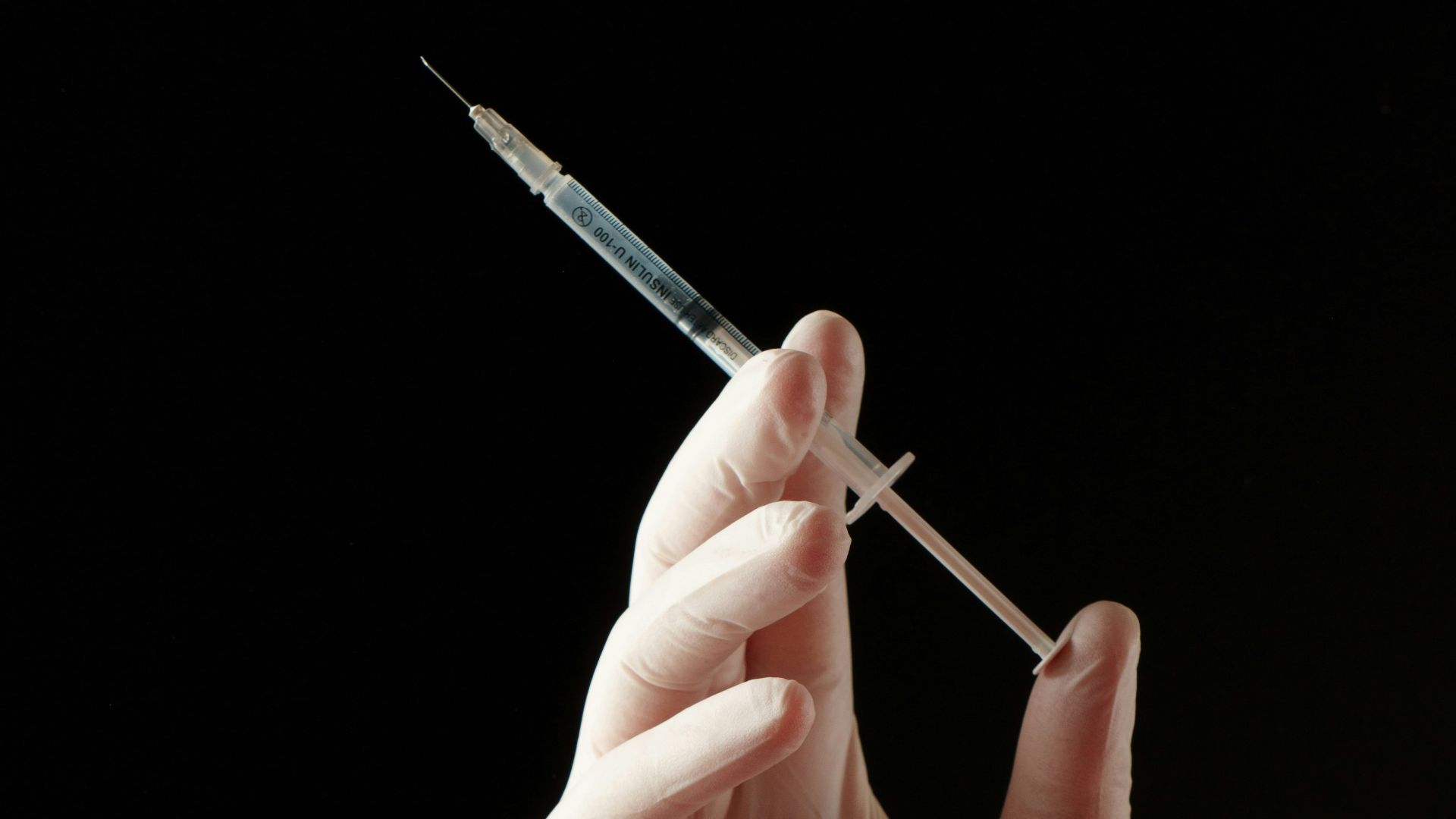 a hand holding a needle
