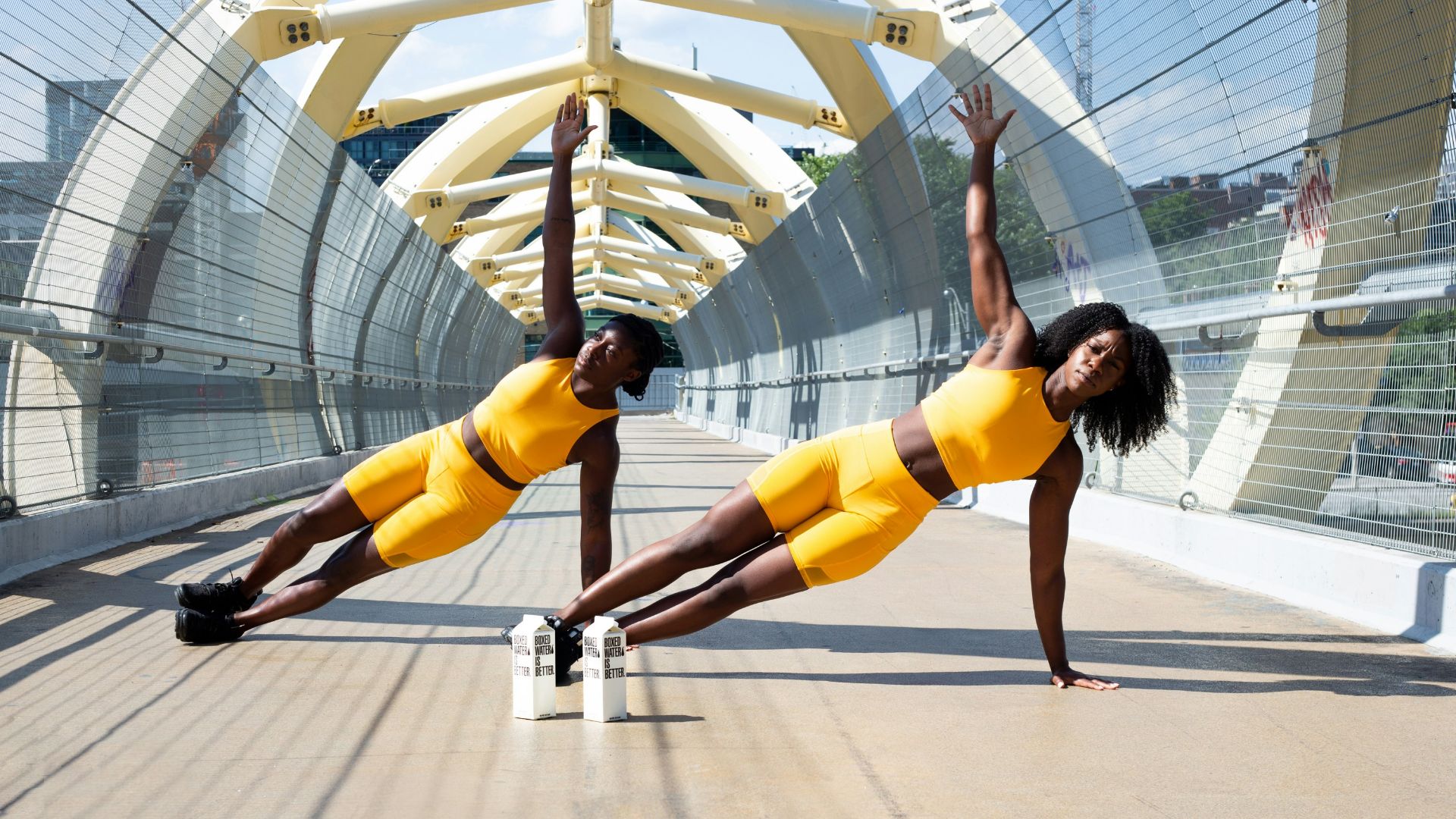 woman in yellow sports bra and yellow shorts jumping on white metal frame