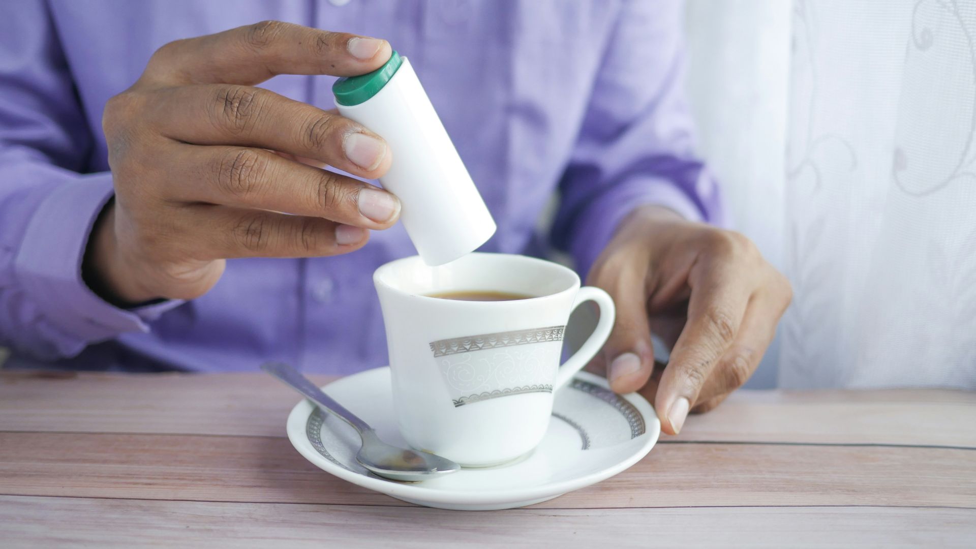 person holding white ceramic mug