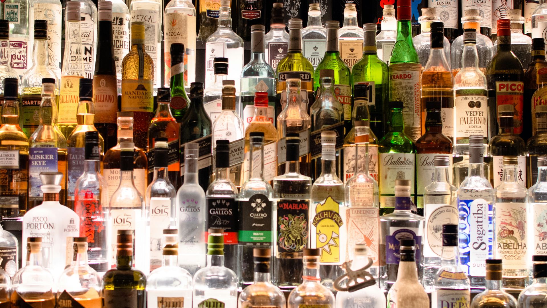 assorted liquor, wines, and whisky on display