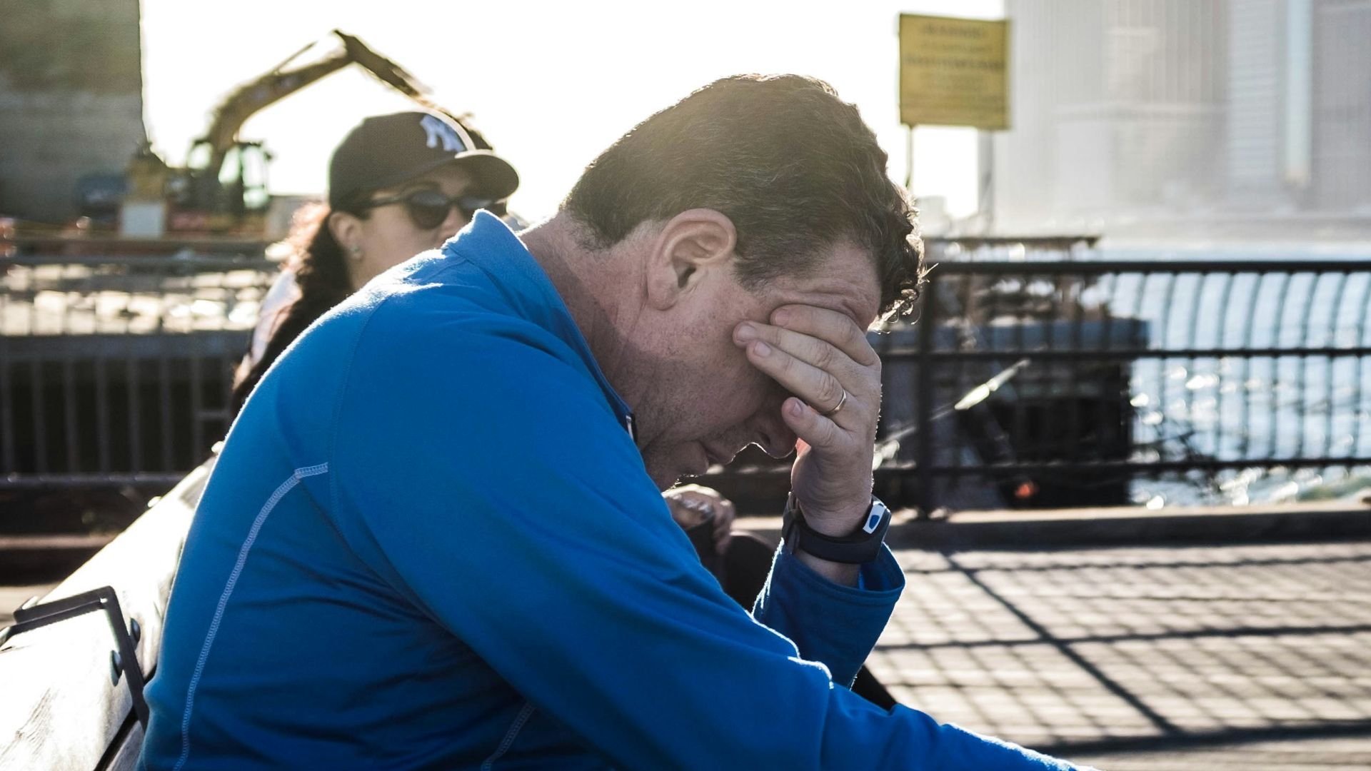 man sitting on bench beside woman