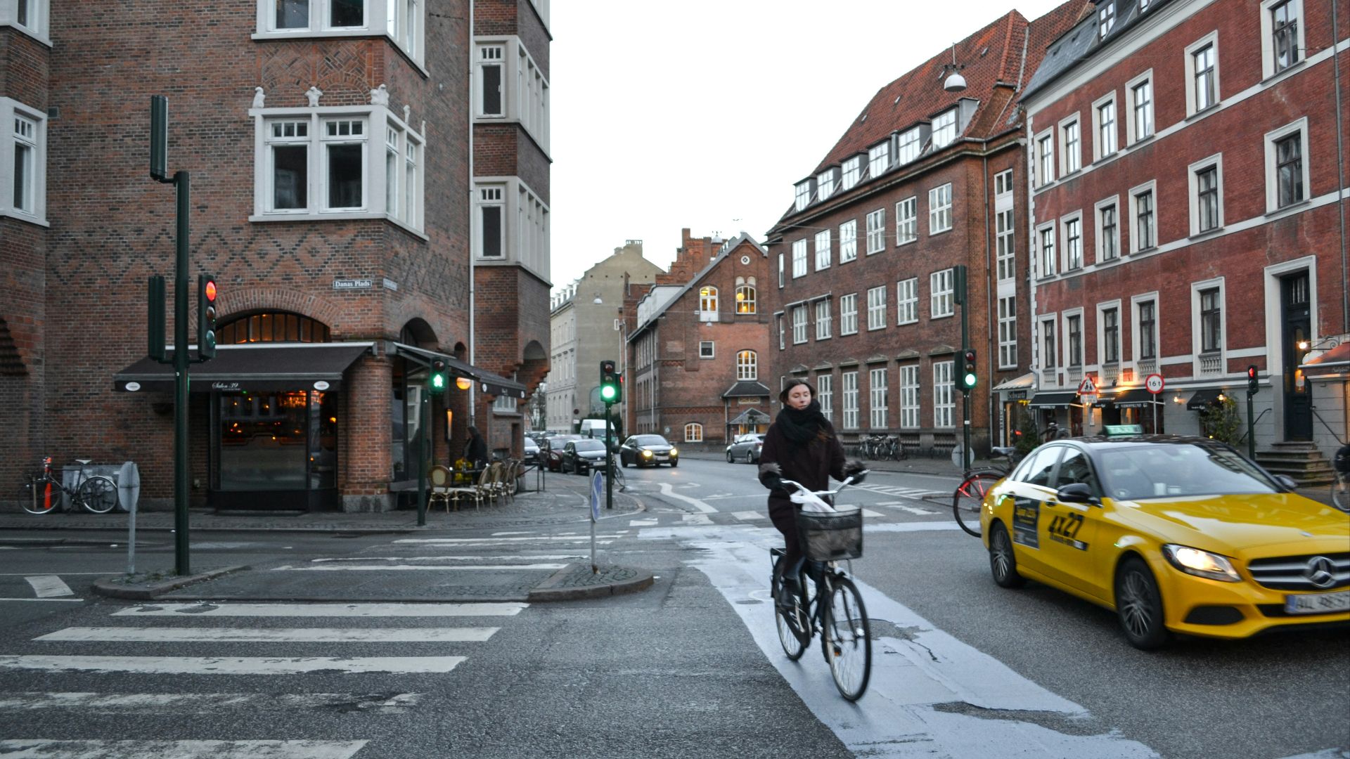 man in black jacket riding bicycle on road during daytime