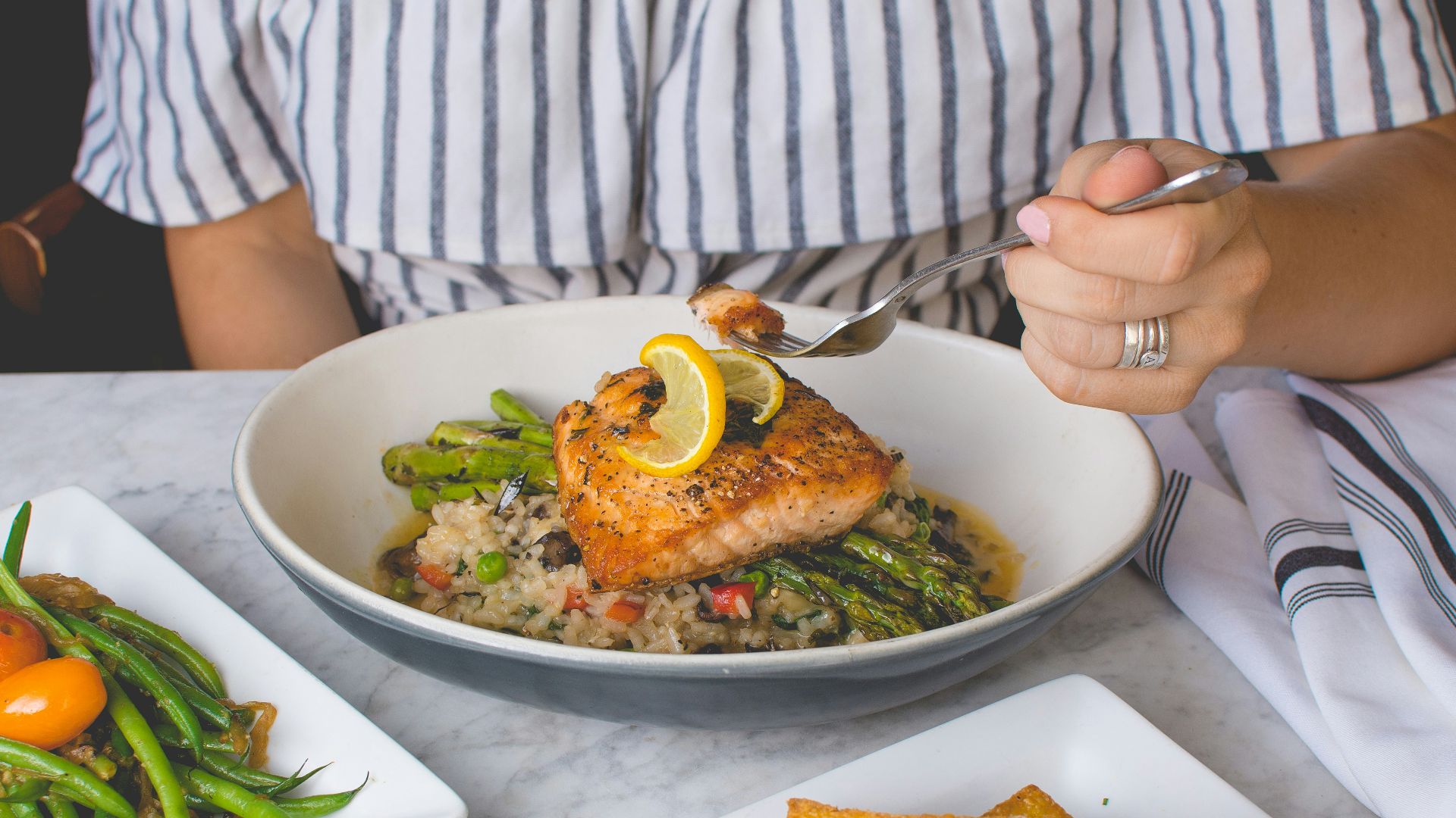 person eating fish meat
