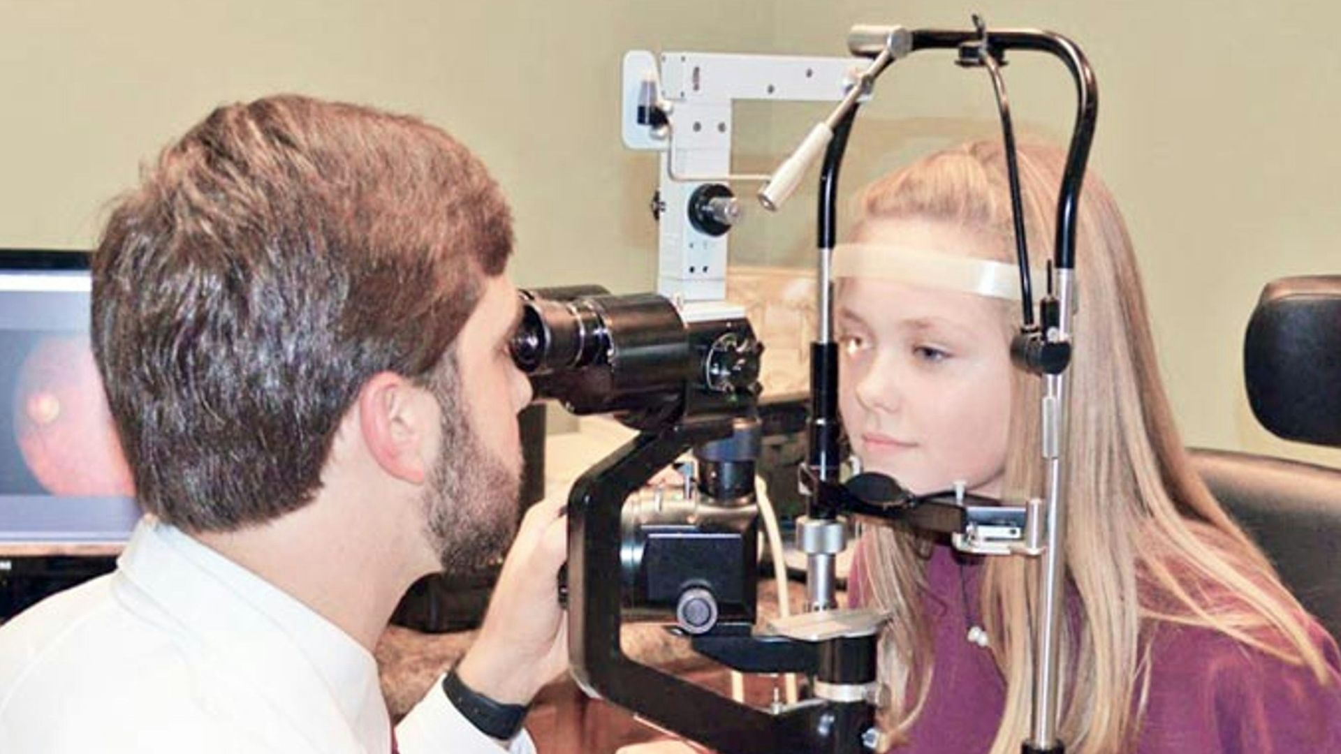 A man and a woman looking through a camera