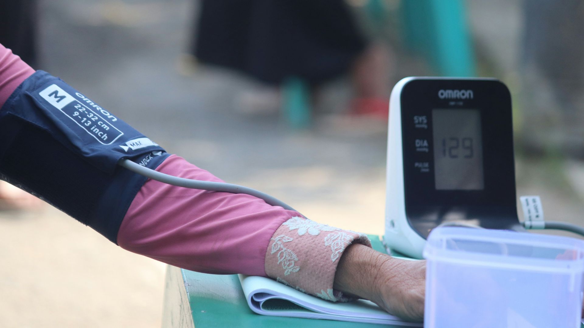 person in pink long sleeve shirt holding white samsung android smartphone