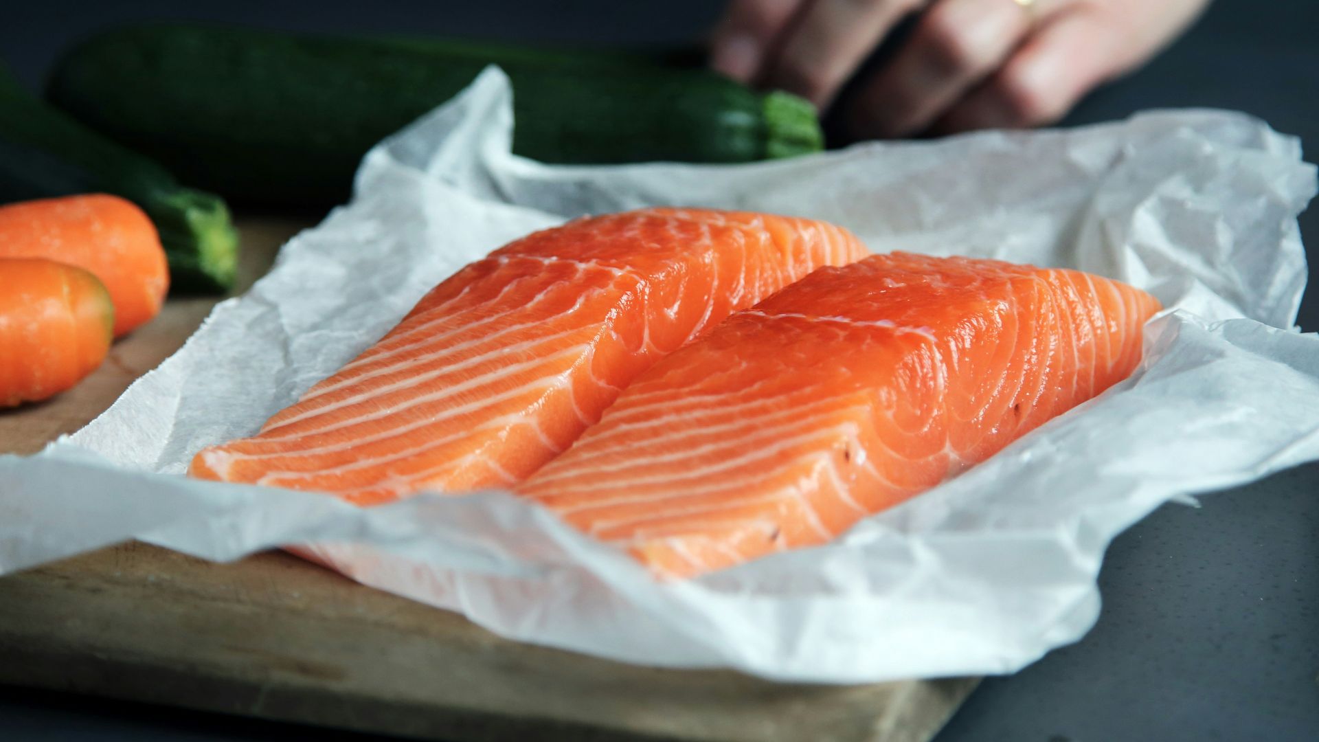 raw fish meat on brown chopping board