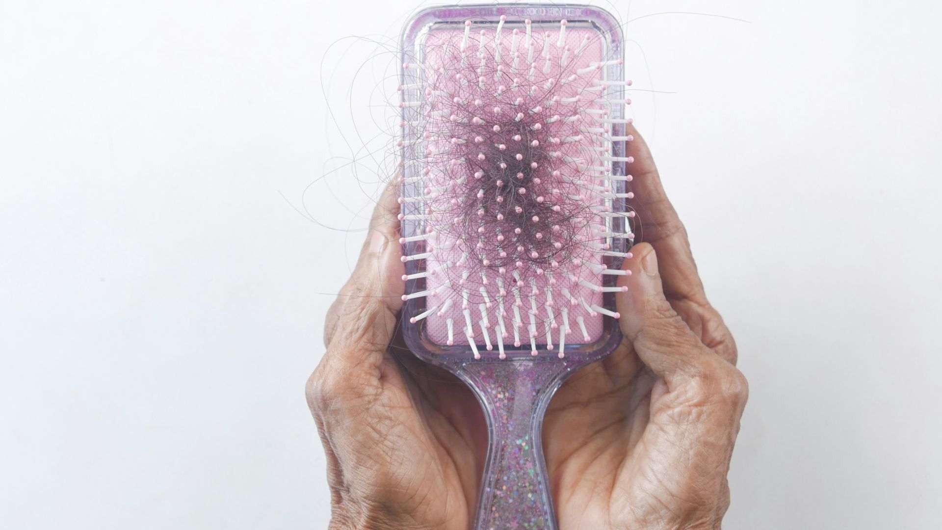 a person holding a hair brush in their hands