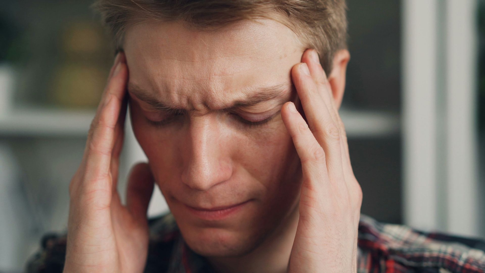 a man holding his hands to his ears