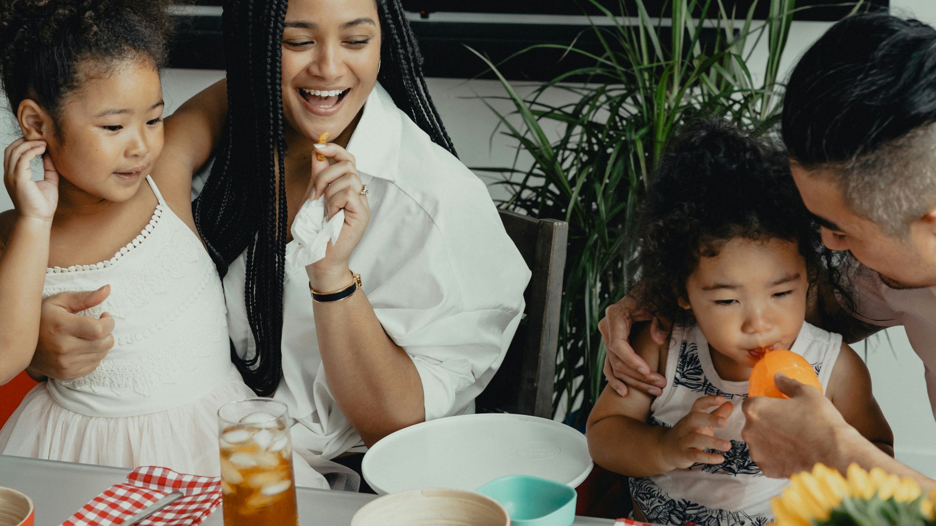woman in white sleeveless dress sitting beside woman in white sleeveless dress