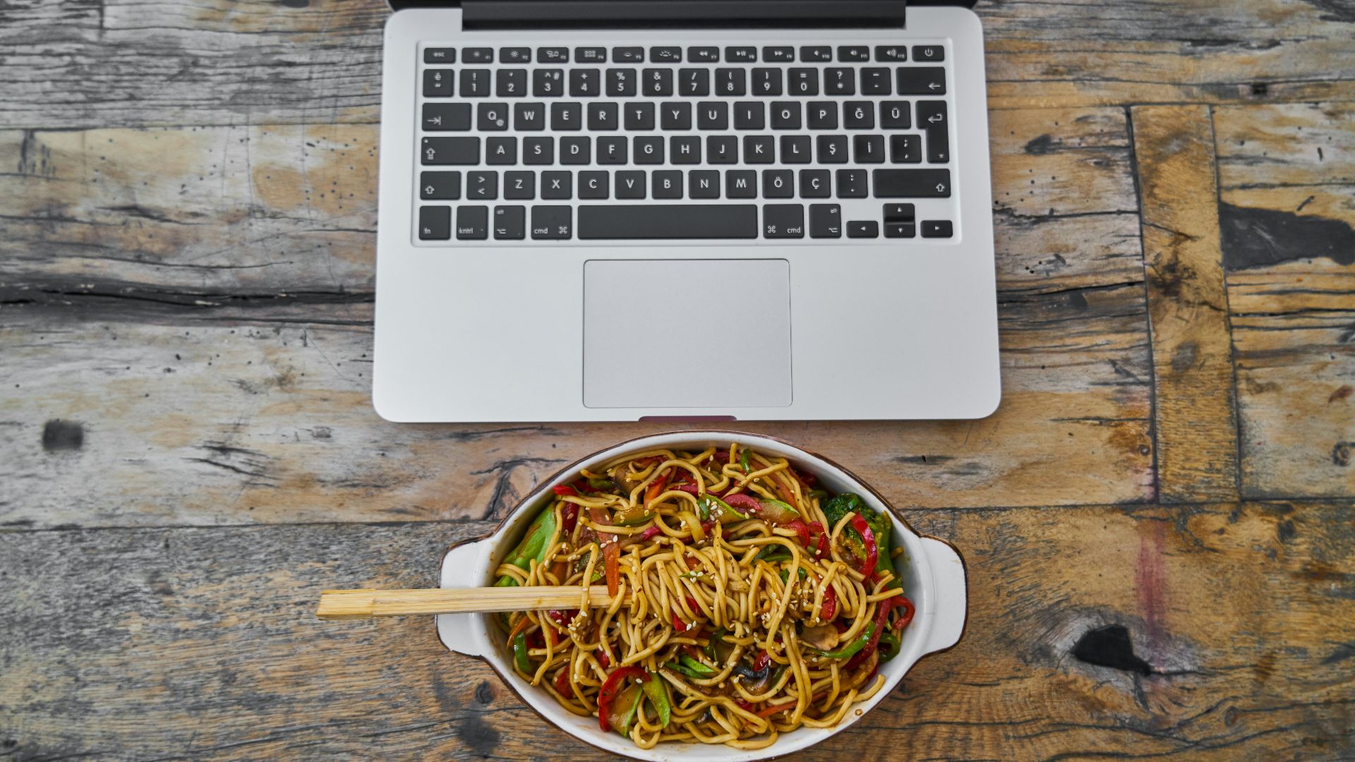 white macbook air on brown wooden table