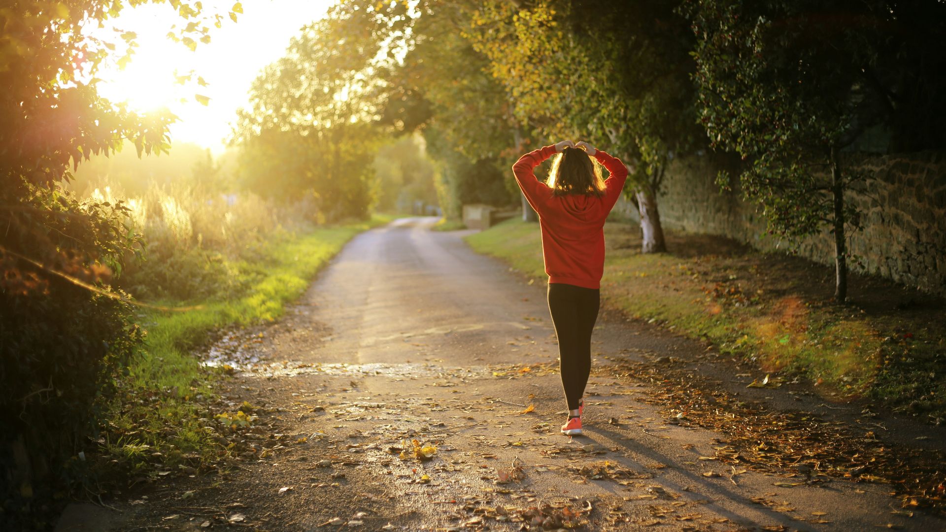 woman walking on pathway during daytime