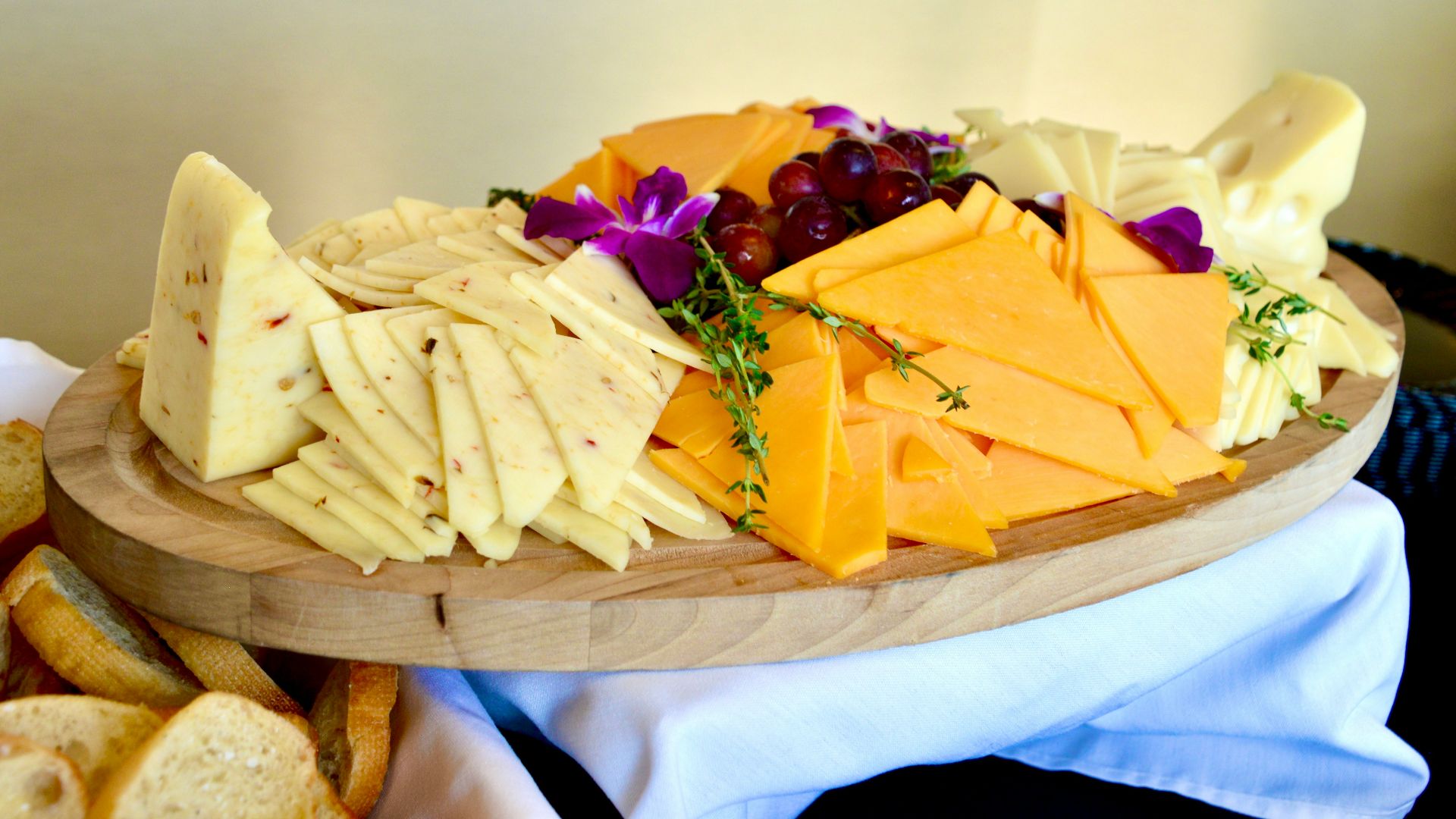 sliced cheese on brown wooden chopping board