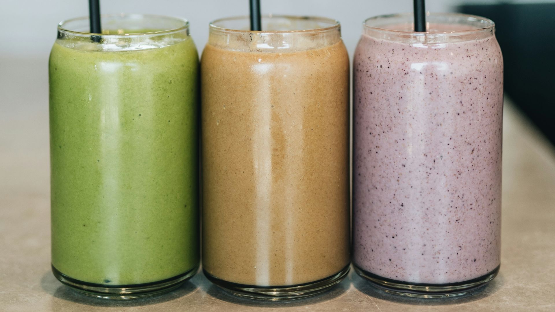 three drinks on gray surface