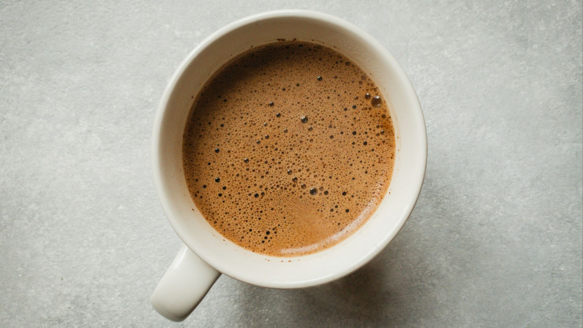 white ceramic mug with brown liquid