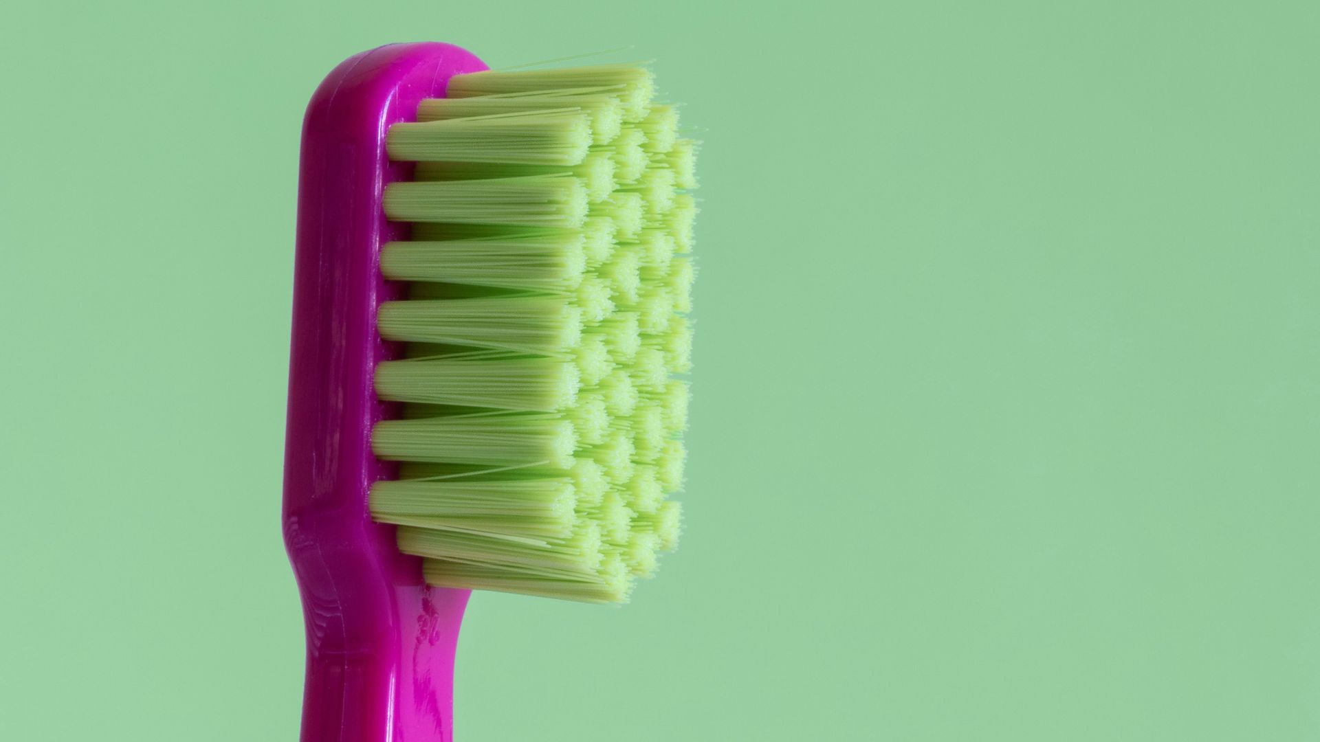 purple and green toothbrush
