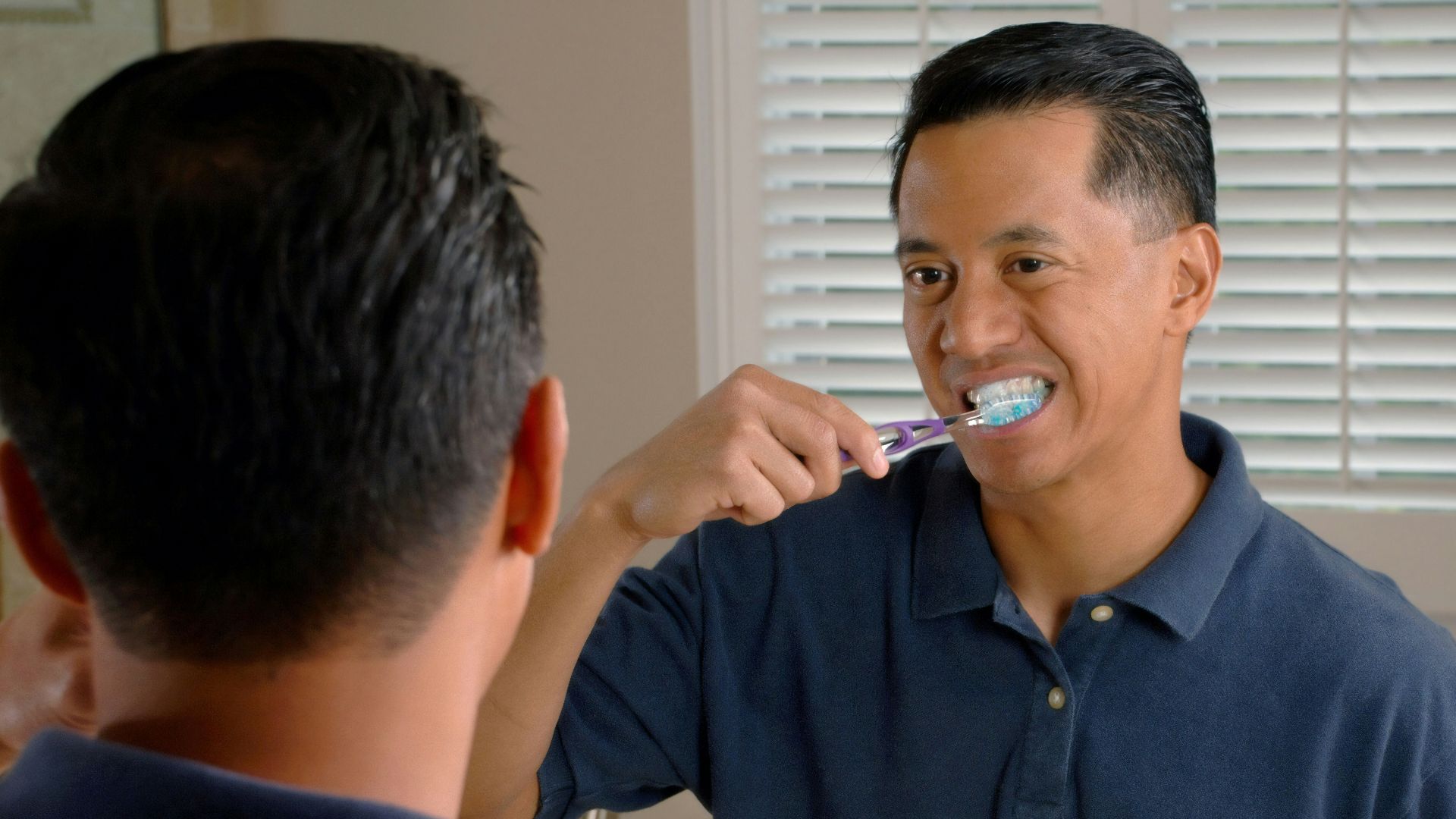 man in blue polo shirt smoking cigarette