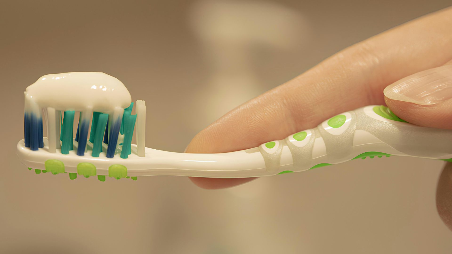 a person is holding a toothbrush with toothpaste on it