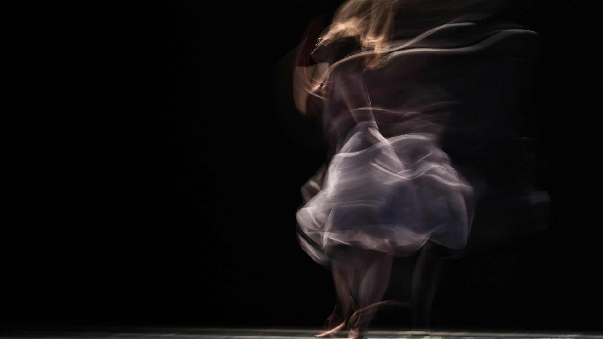 dancing woman on concrete pavement