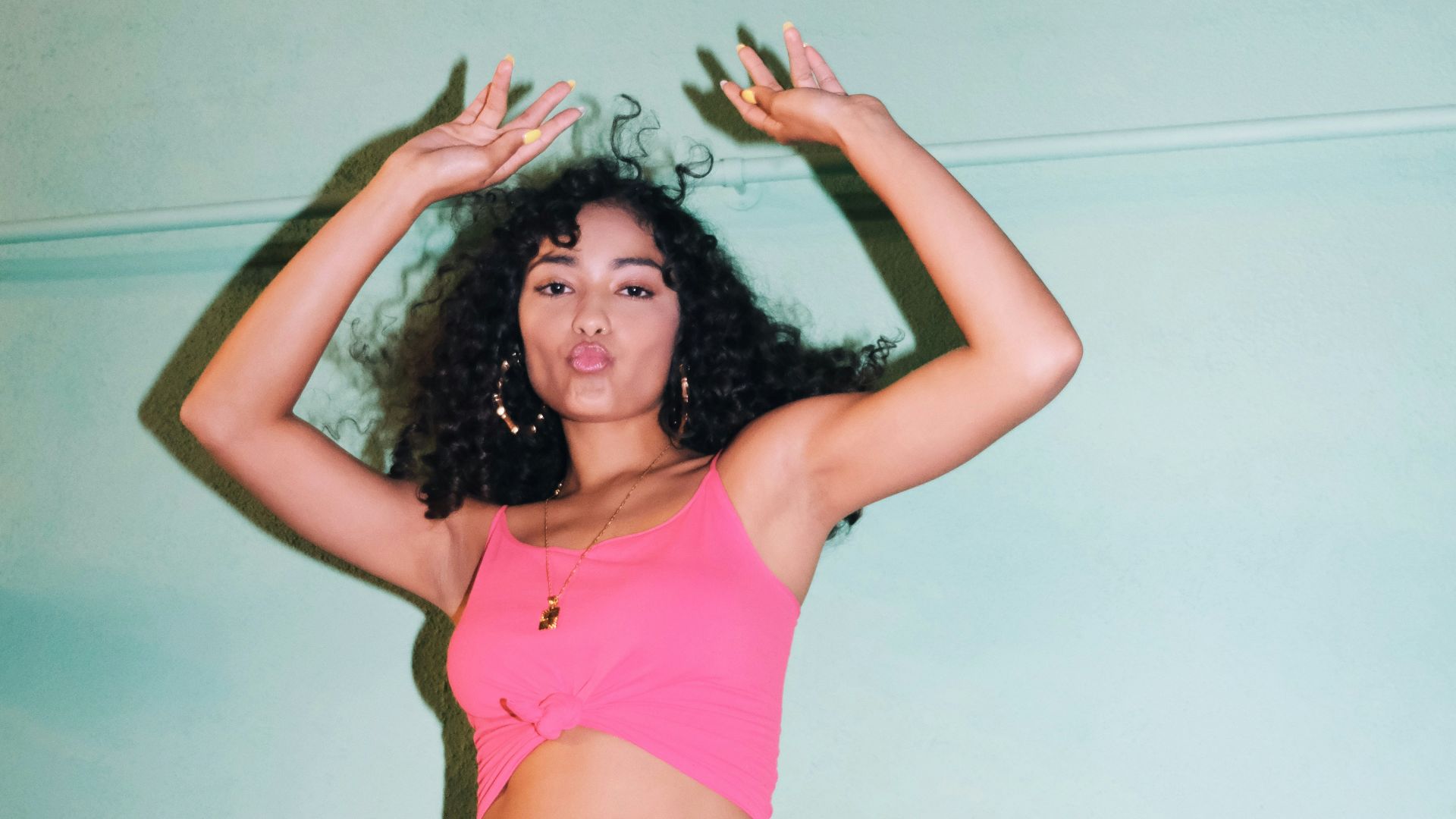 woman in pink tank top and white shorts