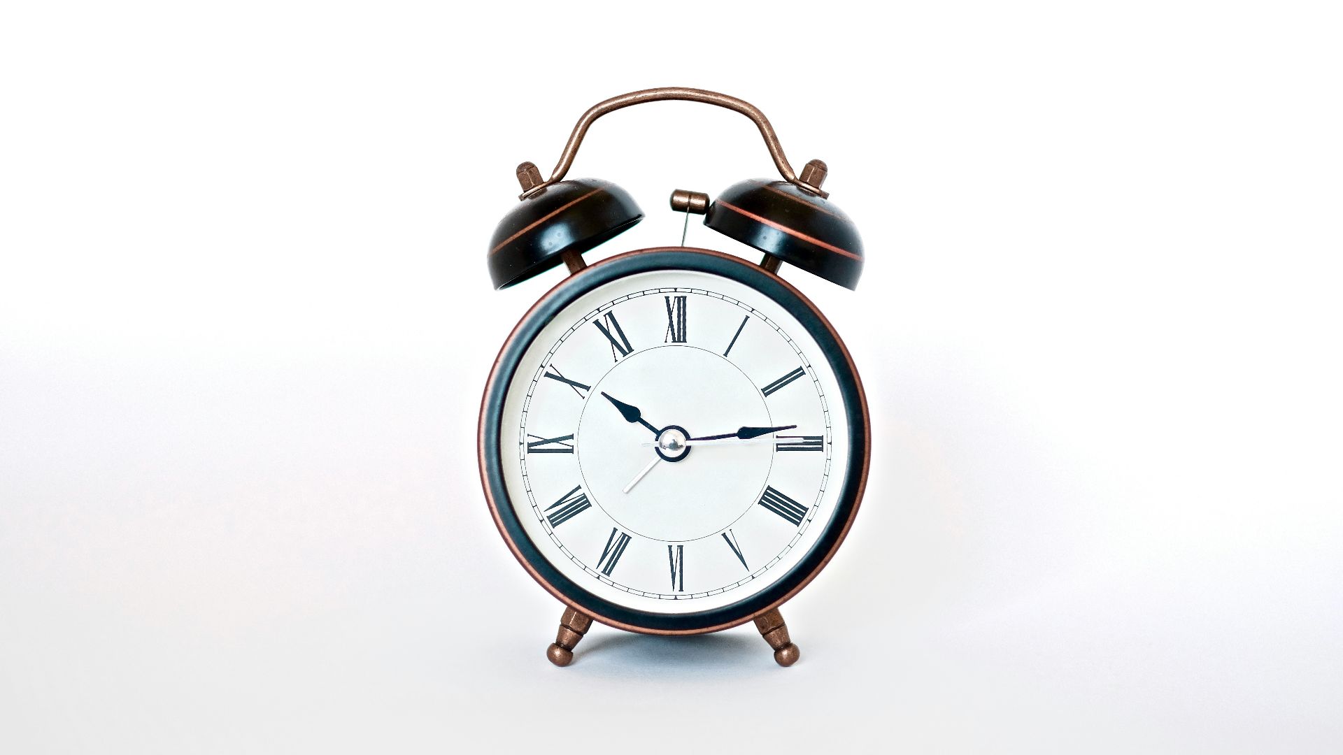 round black and white analog alarm clock