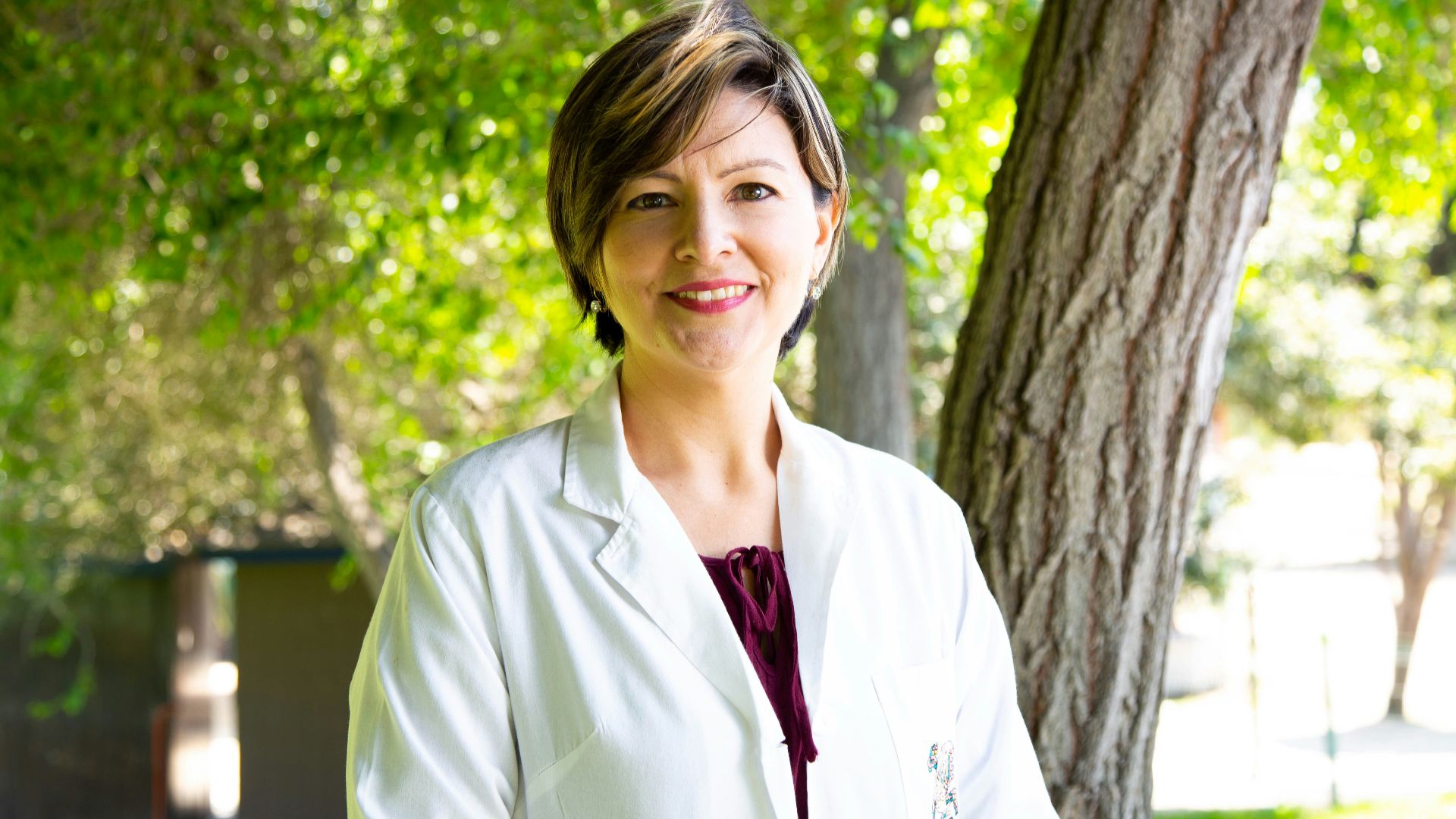 woman standing under tree