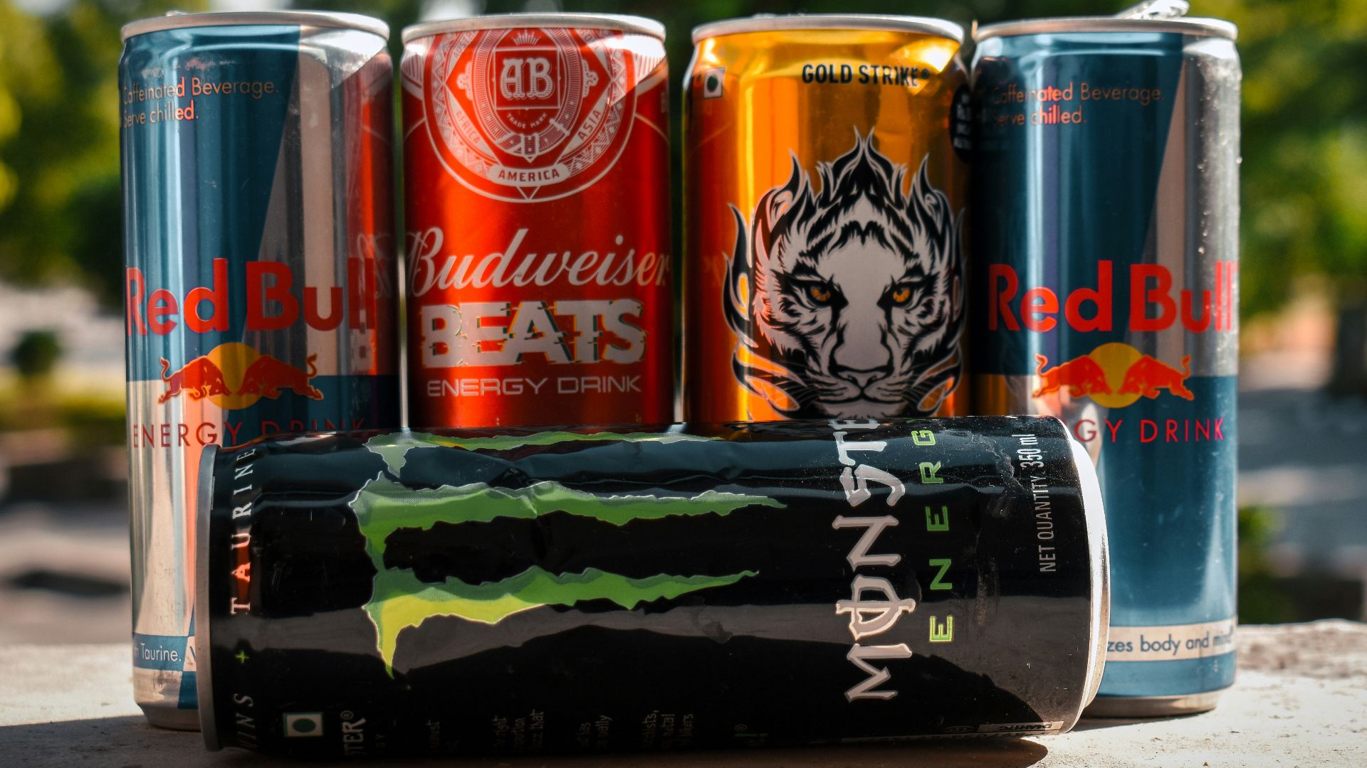a group of four cans of soda sitting next to each other
