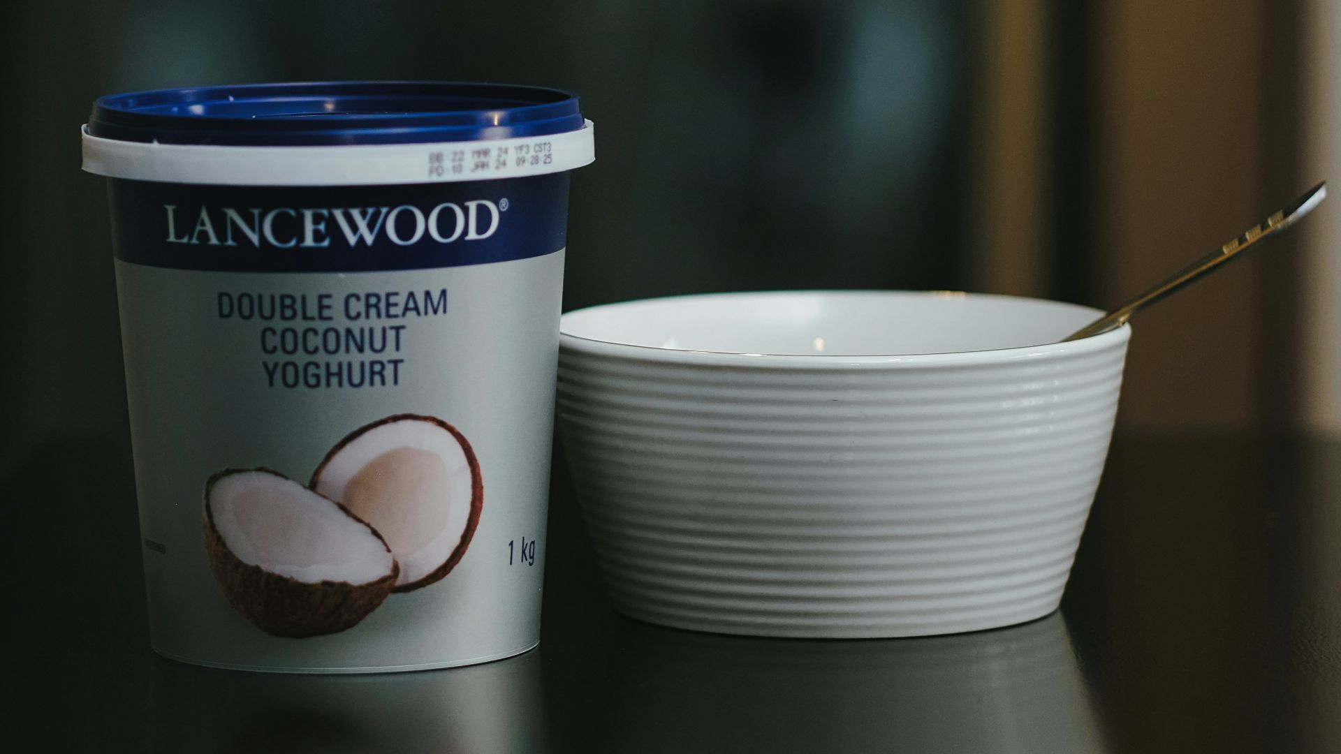 a cup of coffee next to a container of ice cream