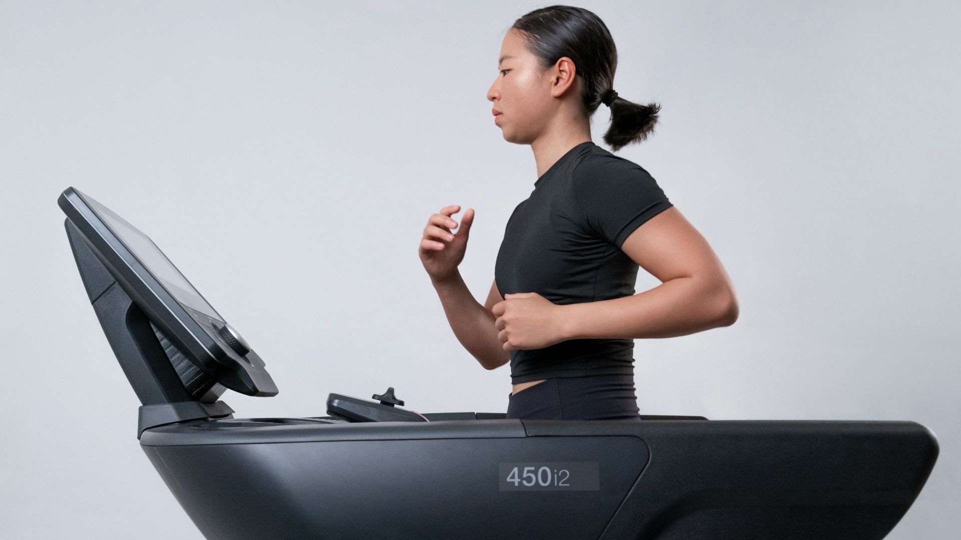 a woman is running on a treadmill