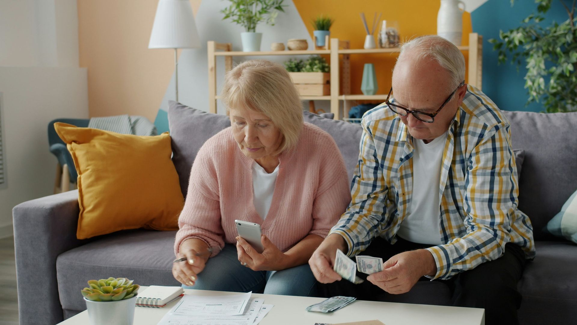 Elderly couple managing finances at home