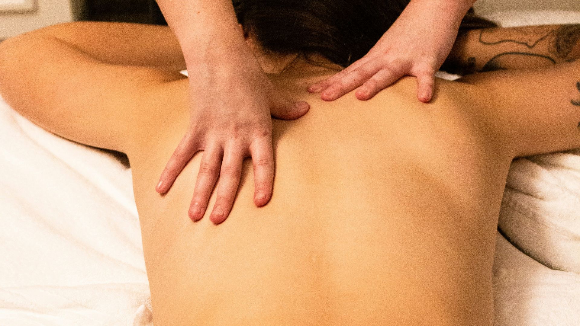 a woman getting a back massage at a spa