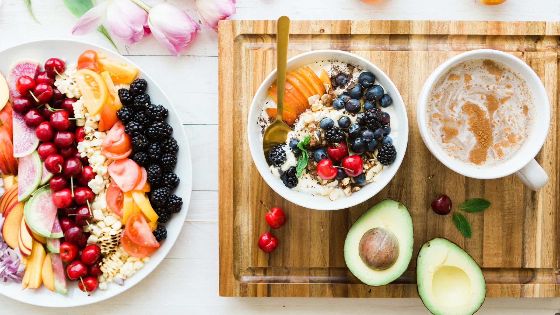 black and red cherries on white bowl