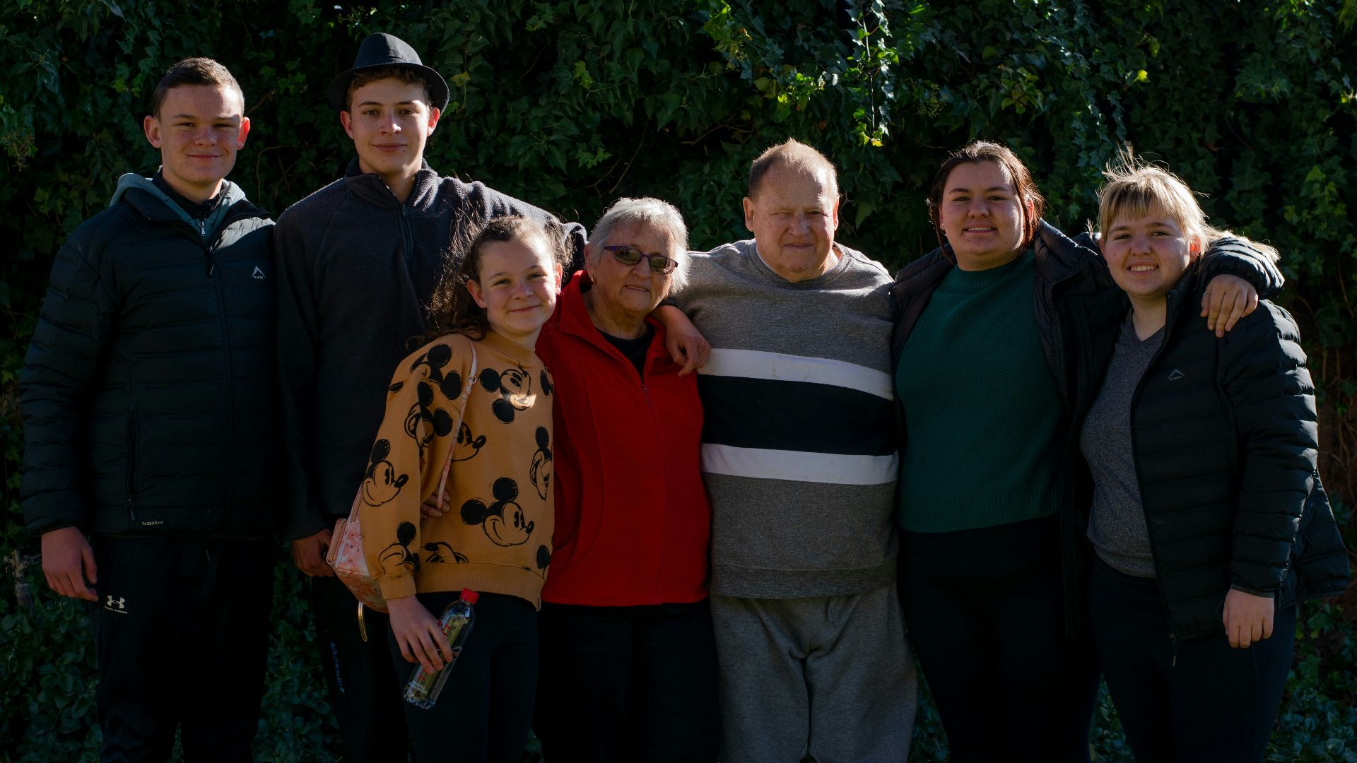 group of people standing near green trees during daytime