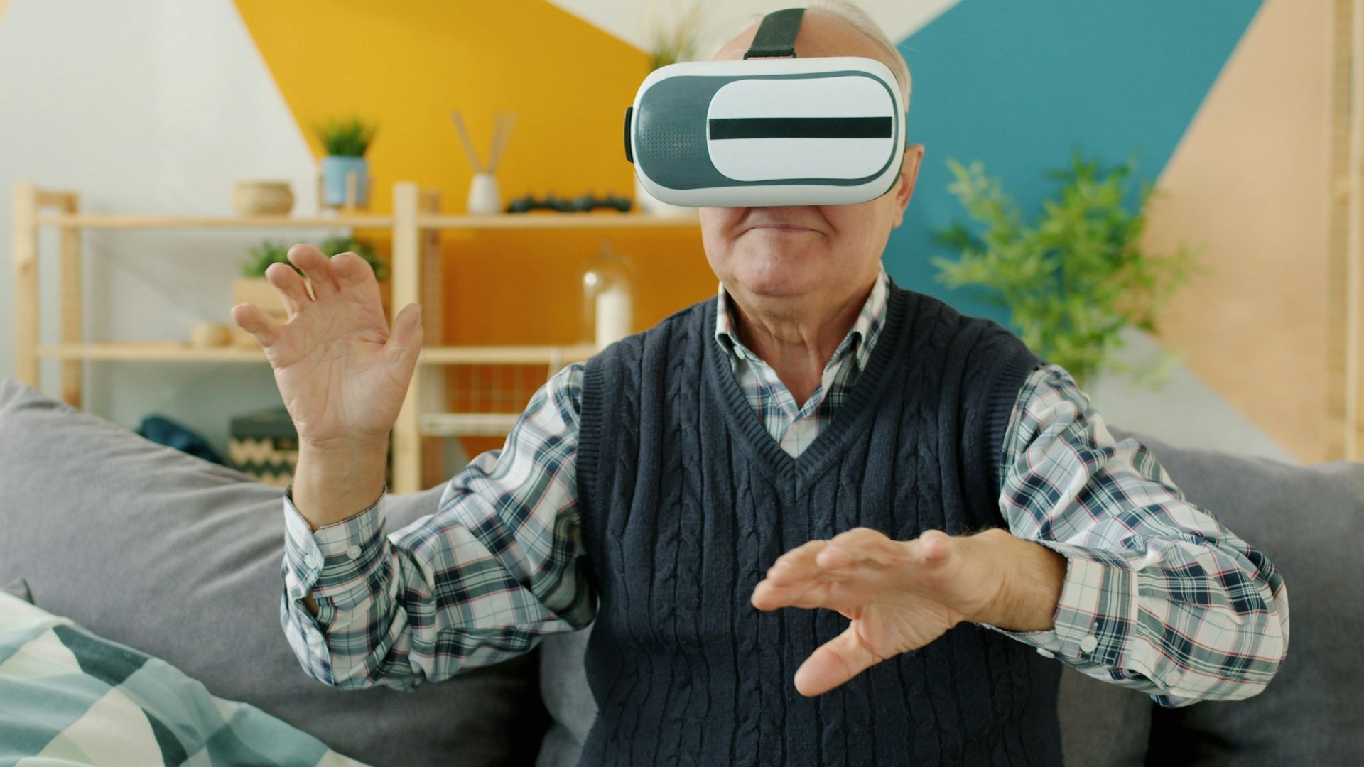 Elderly man using virtual reality headset at home.