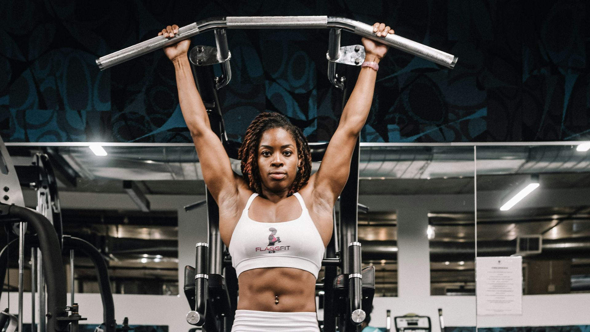 woman in white tank top and white pants doing exercise