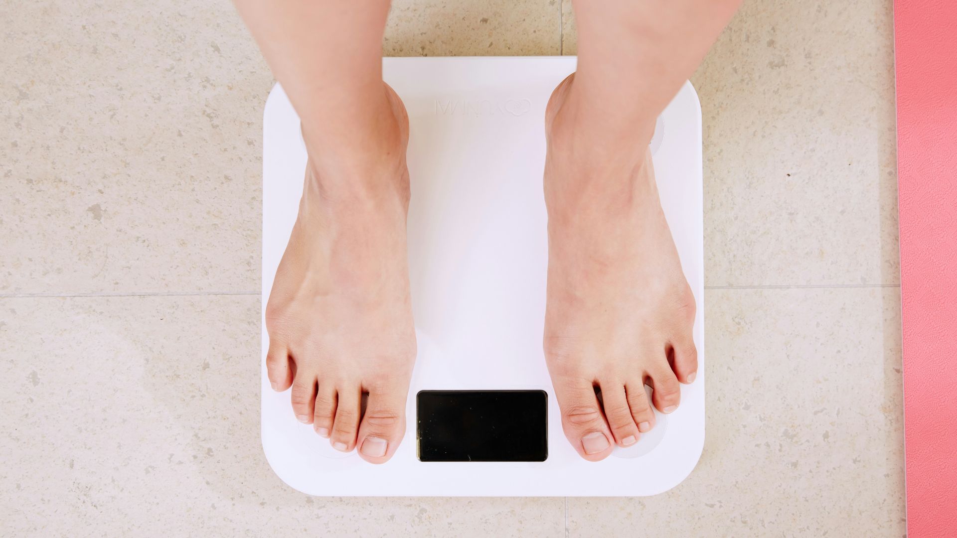 person standing on white digital bathroom scale