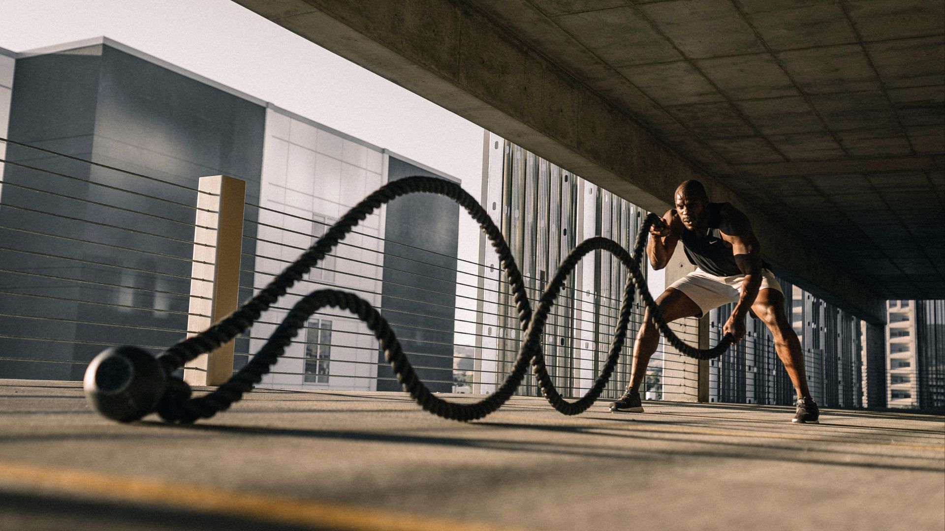 woman in black tank top sitting on brown wooden bench